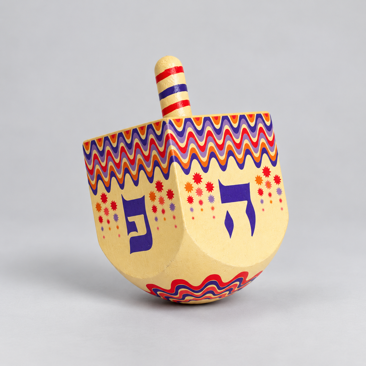 cream and colourful wooden dreidel 